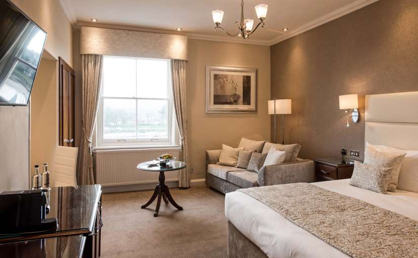 Imperial Hotel Deluxe Room (203) Accommodation Bed with Seating Area