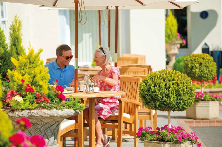 Imperial Hotel Couple Enjoying Tea at the Outside Seating Area